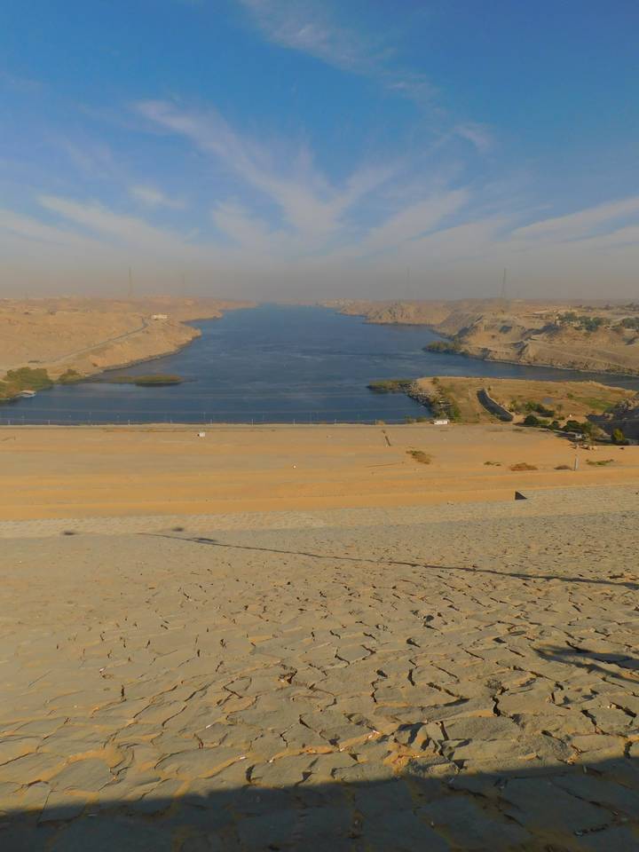 Stone embankments along a river with arid landscape.
