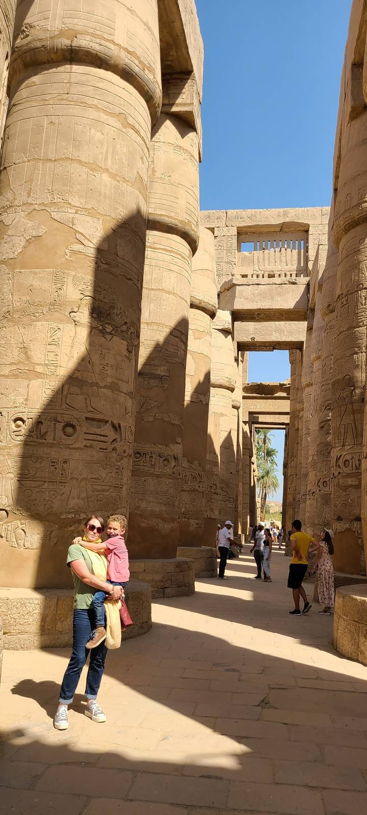 Family posing among ancient columns in Egypt.