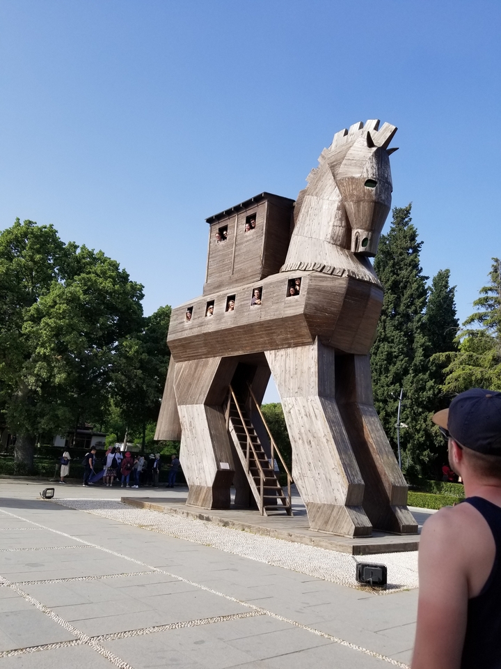 Replica of the Trojan horse with visitors around.