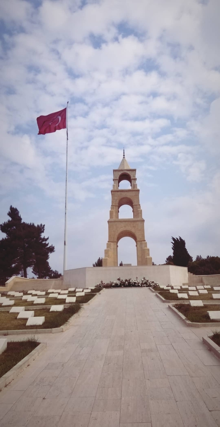 Gallipoli Memorial with trees and a flagpole.