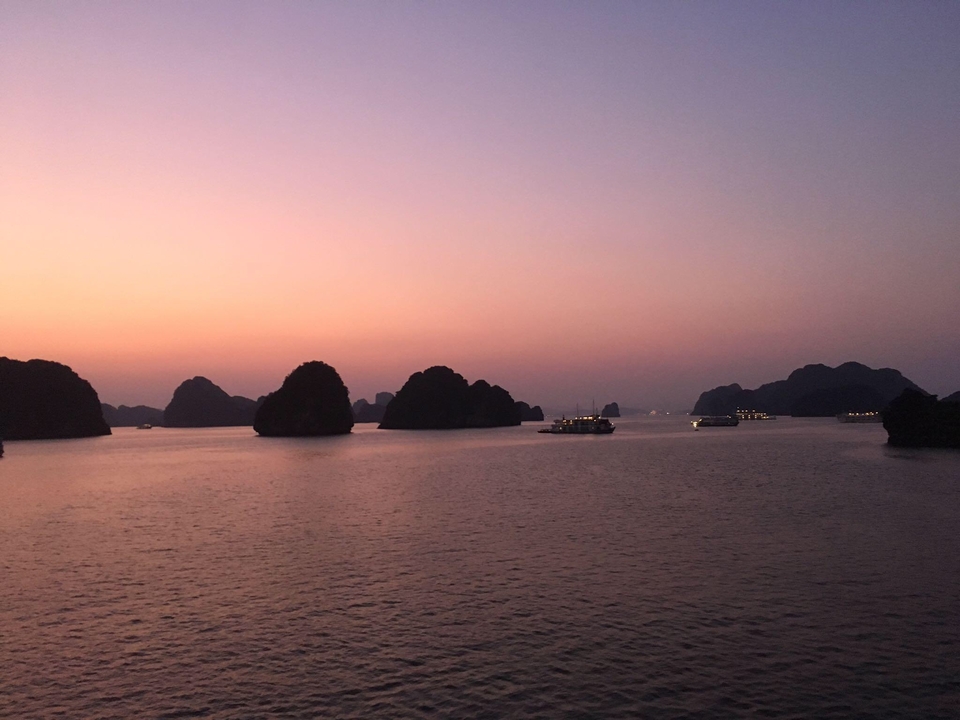 Sunset view over a bay with silhouetted islands.