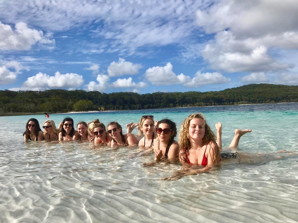 Group of people in the water at a tropical beach.
