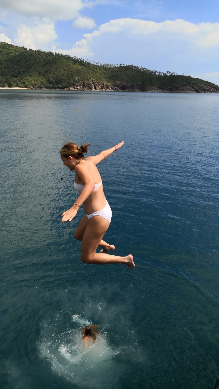 Person jumping into the sea, enjoying an adventurous moment.