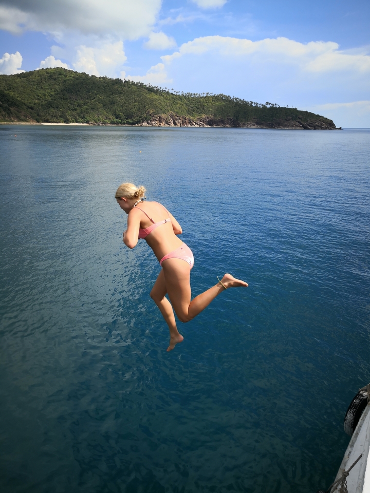 Person jumping into the sea from a boat.