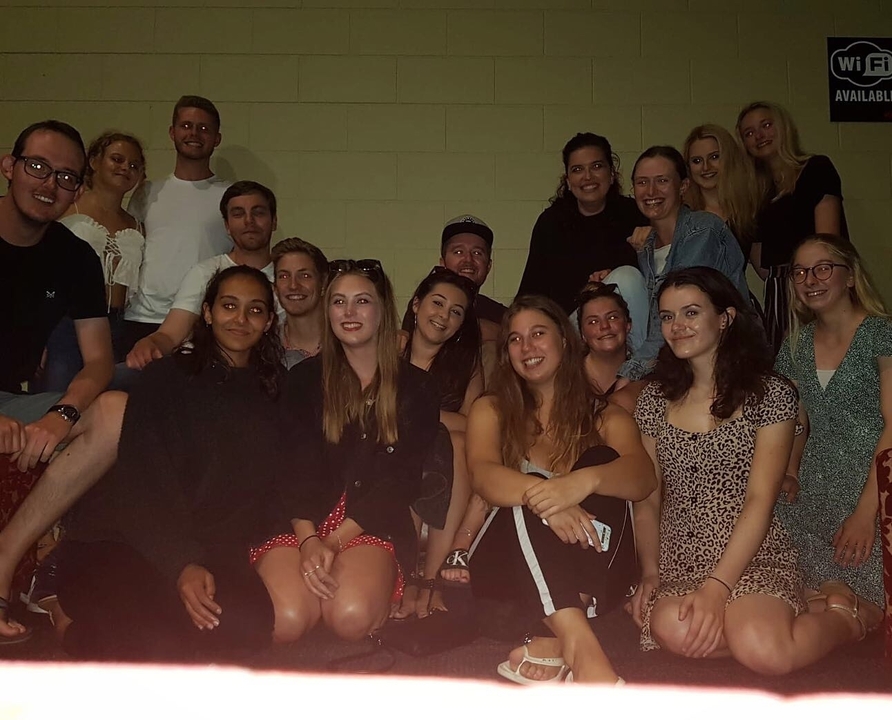 Group of people sitting together indoors.