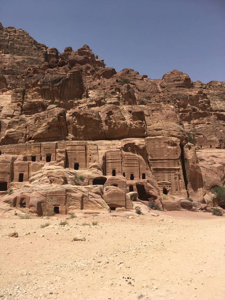 Ancient rock-cut architecture in a desert landscape.