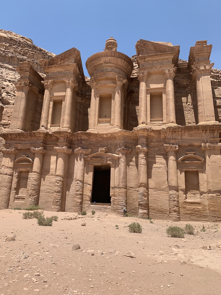 Facade of Al-Deir in Petra with sunlight.