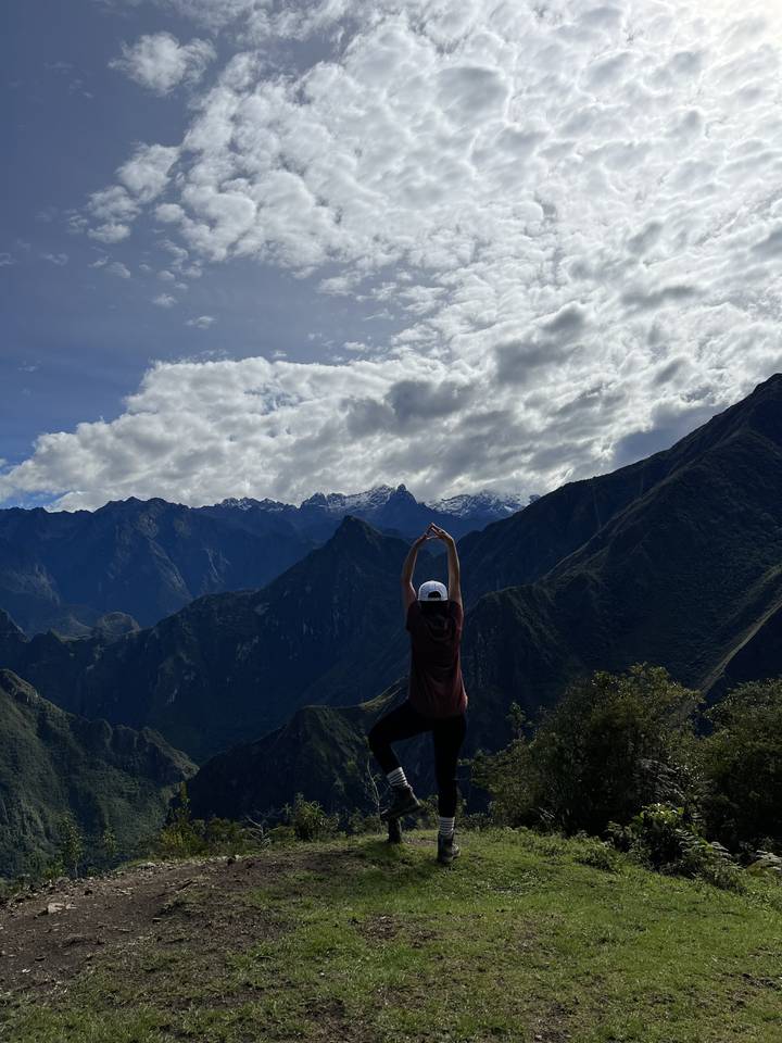 Person meditating with mountain views.