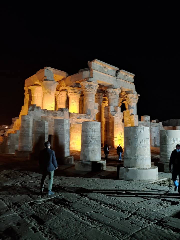 Ancient temple ruins lit at night.