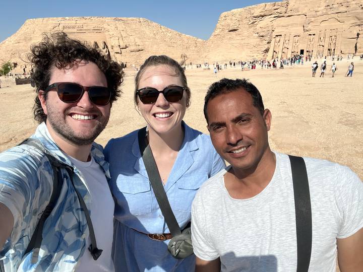 Upside-down group selfie in front of ancient ruins.