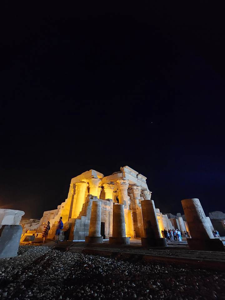 Ancient temple structure lit at night.