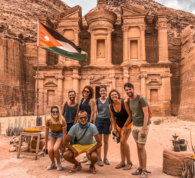 Group of people posing in front of Petra.