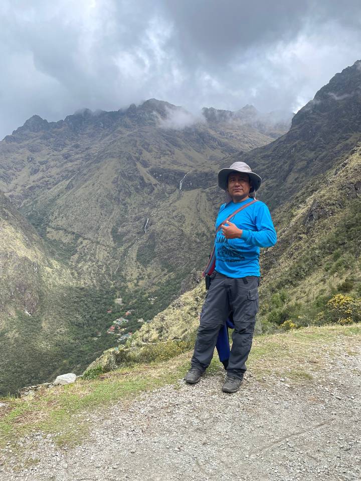 Guide posing with scenic mountain background.