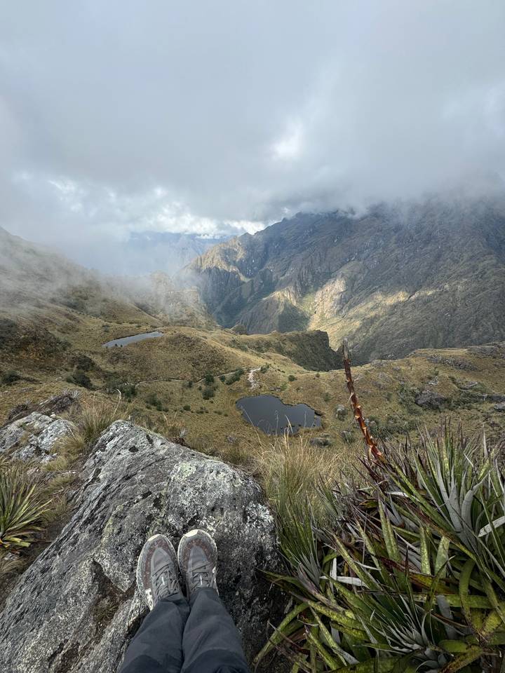 Scenic mountainous landscape with mist and ponds.