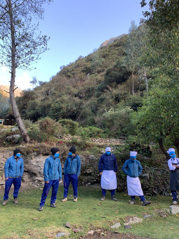 Group of people in blue outfits standing in a line.