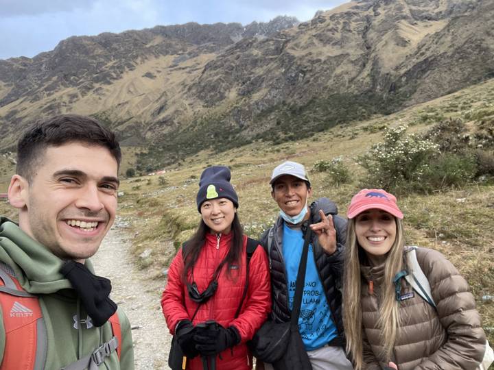 Group of people smiling with mountains in the background