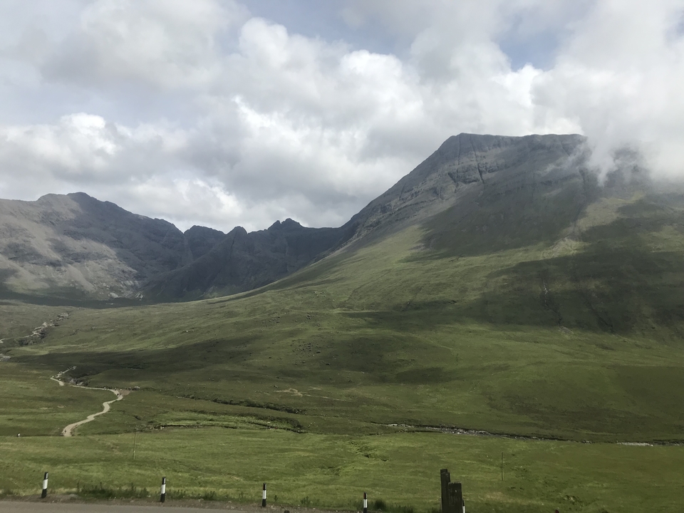 A vast mountainous landscape with cloudy skies adding to its drama.