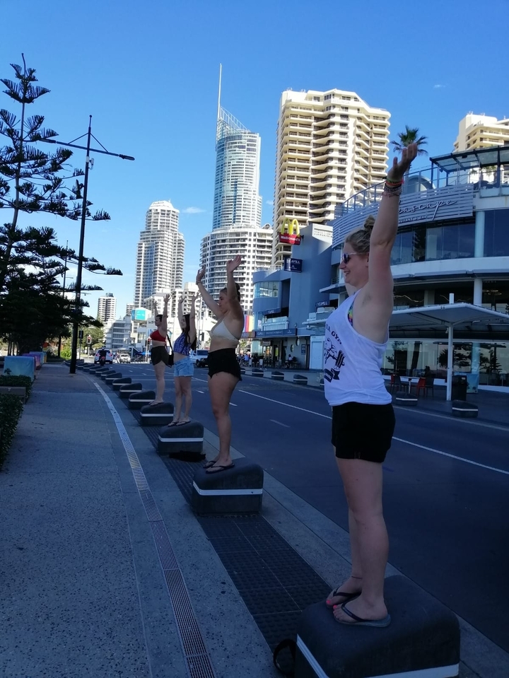 People posing in a city with tall buildings.