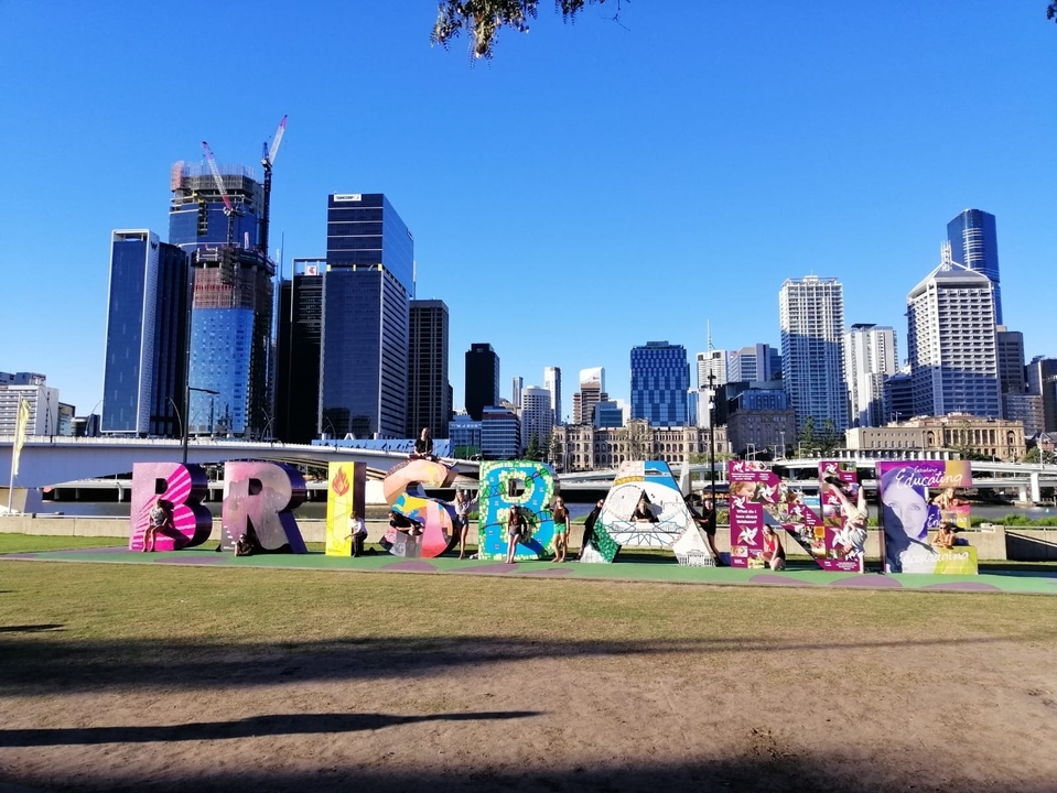 Cityscape with colorful BRISBANE sign.