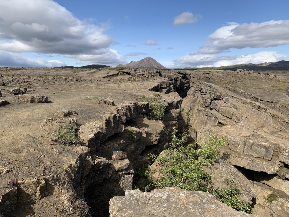 Rugged landscape with a crack running through rocky terrain.