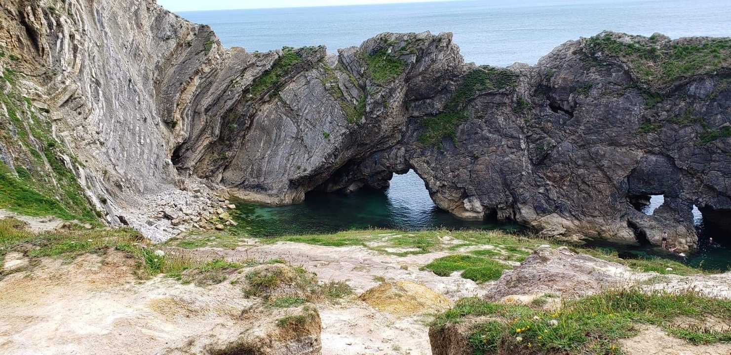 Dramatic coastal arch with turquoise water.