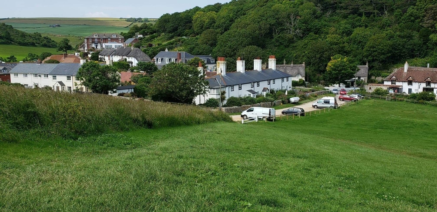 Small village surrounded by lush hills.