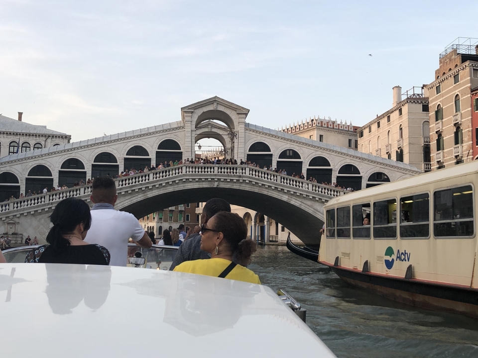 Iconic bridge over a crowded canal with boats.
