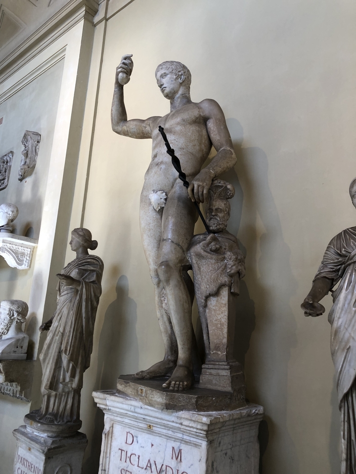 Marble statues in a museum with visible cracks.
