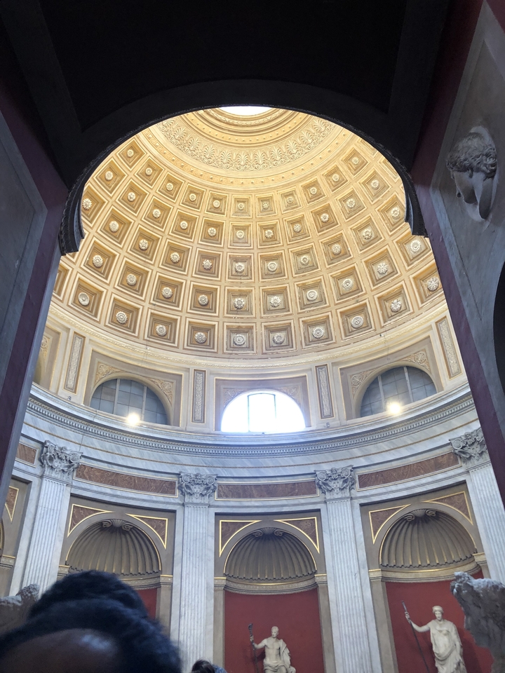 Intricate domed ceiling with light fixtures.