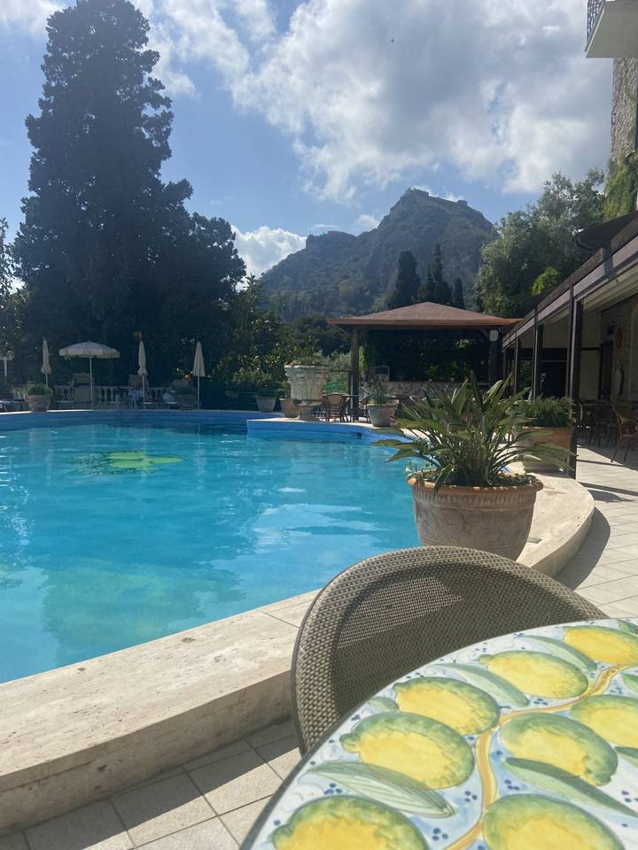 Poolside view with mountains in the background.