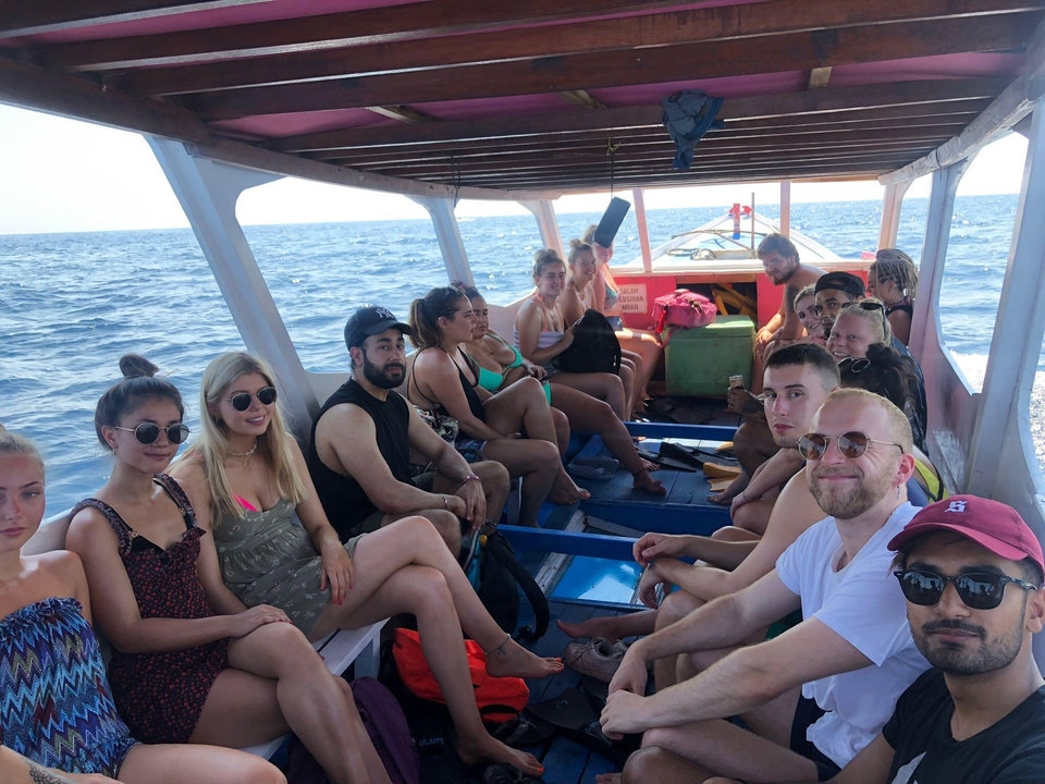 People sitting inside a boat on a water body.