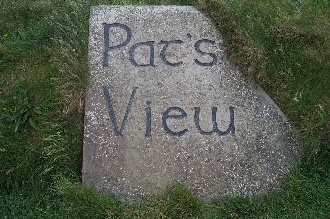 A stone with engraved text 'Pat's View'.