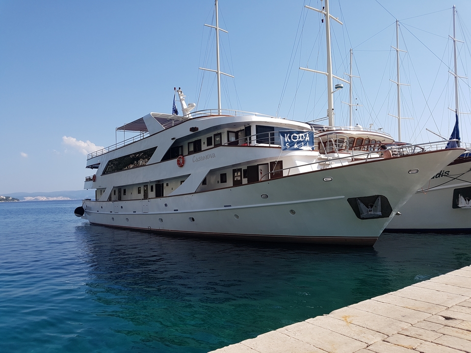 Docked boat with clear blue water and a bright sky.