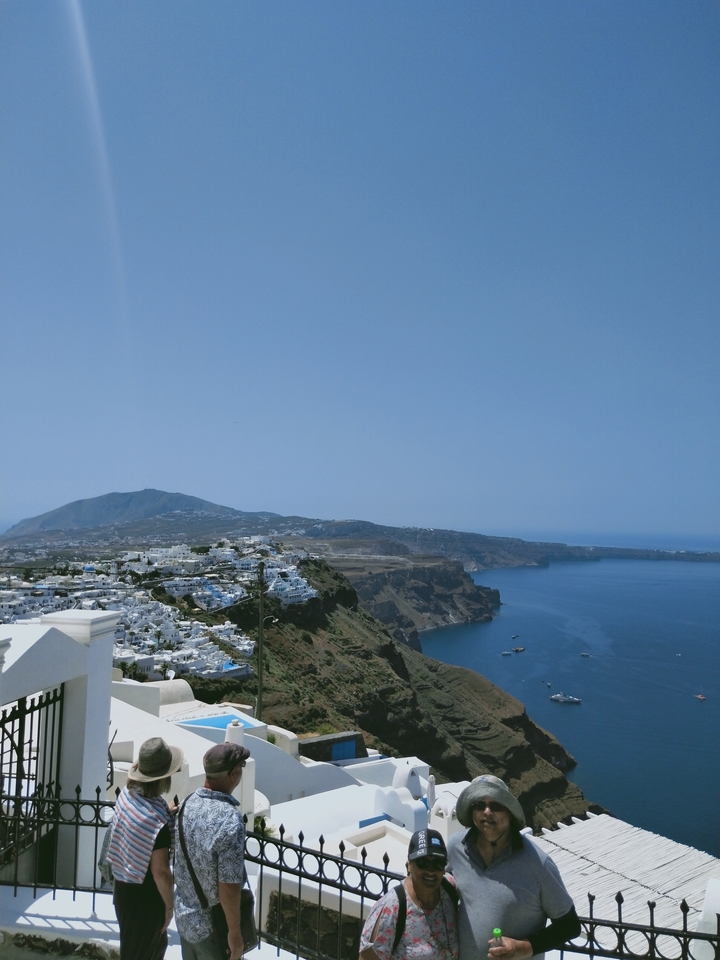 Hilly coastal landscape with white buildings.