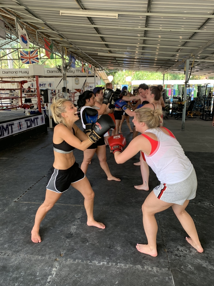 Group boxing class taking place with participants practicing.