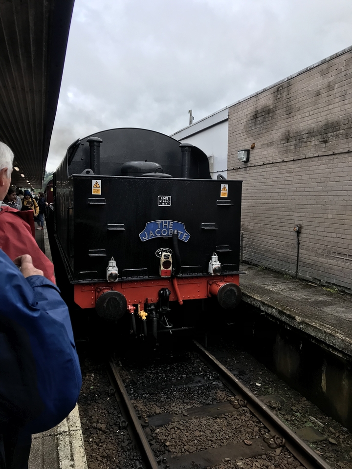 The Jacobite steam train parked at a station.