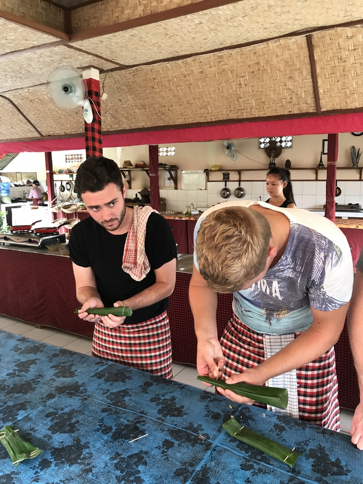 Two men cooking indoors at a counter.