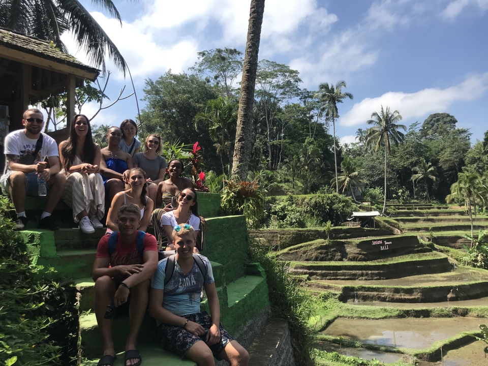 Group sitting in front of rice terraces.