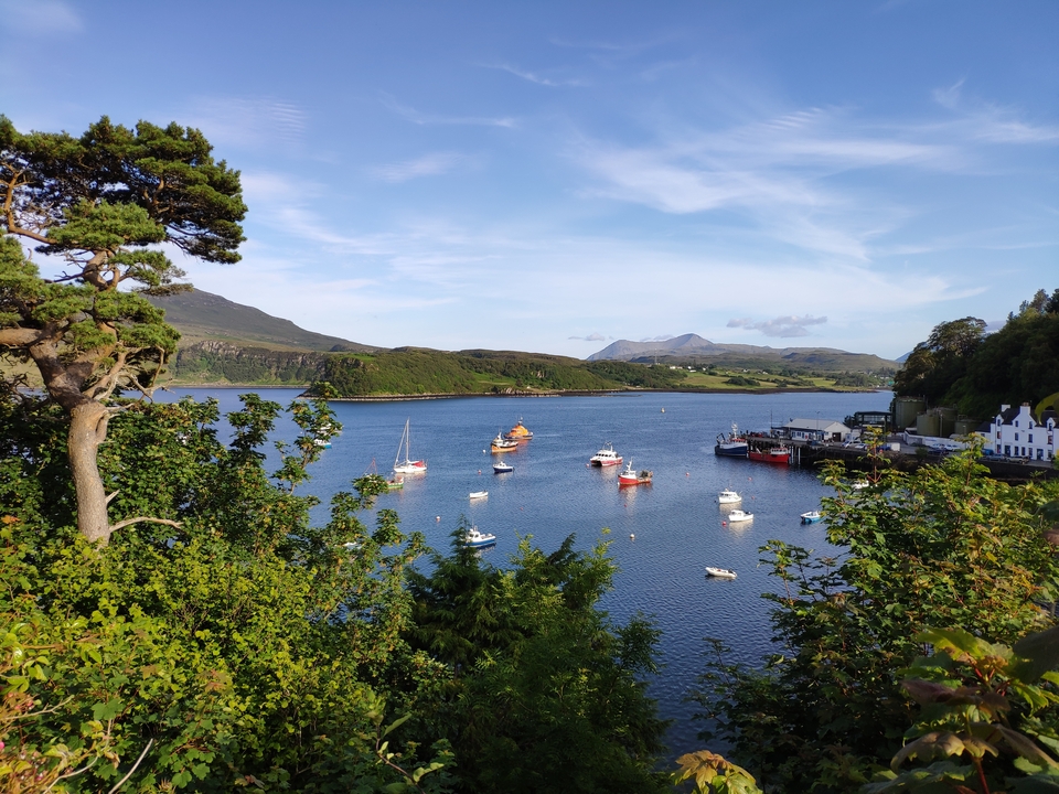 View of a bay with boats and surrounding hills.