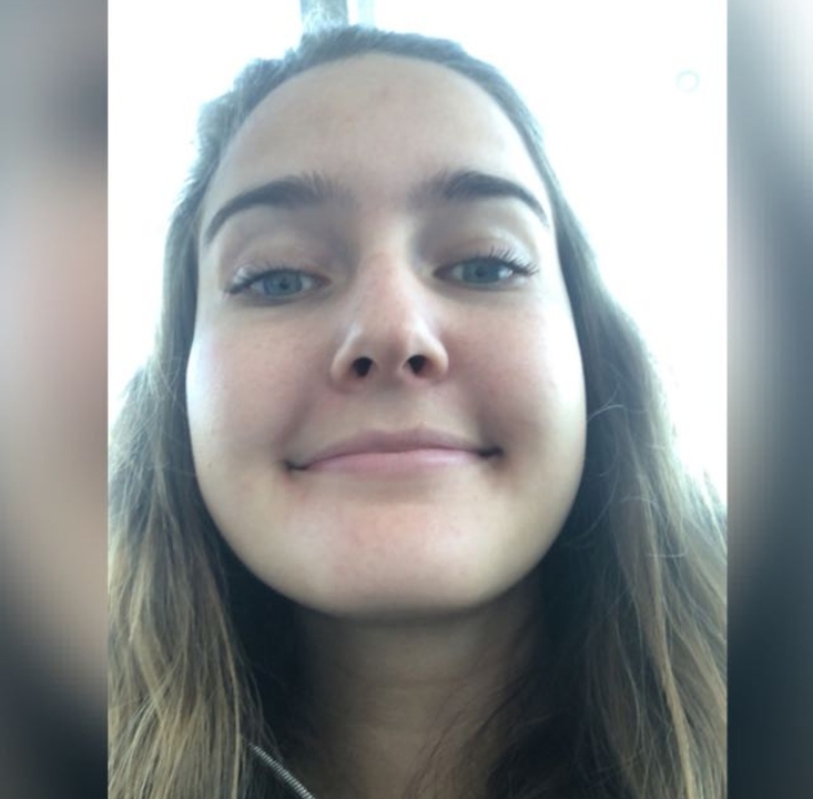 Close-up selfie of a person smiling.