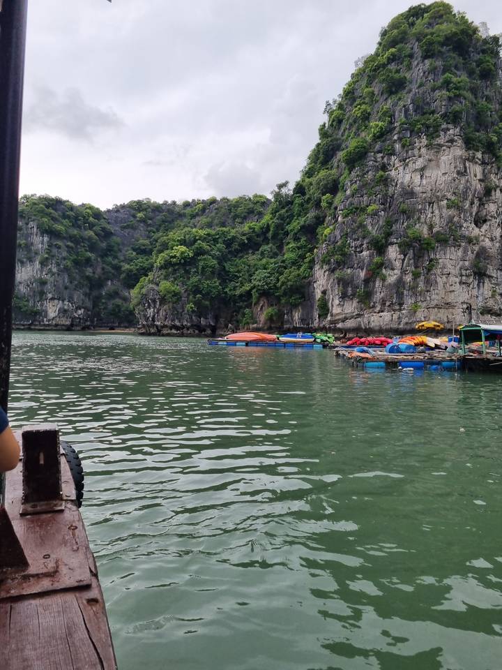 Kayaks in a bay surrounded by cliffs.