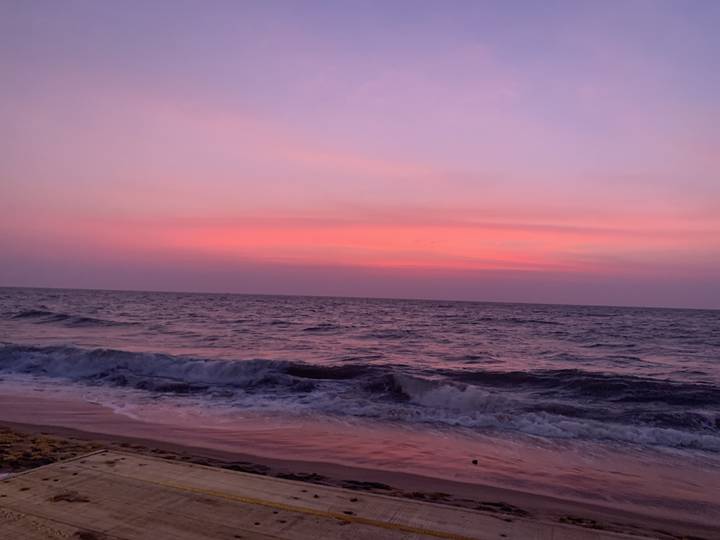 Sunset over the ocean with colorful sky.