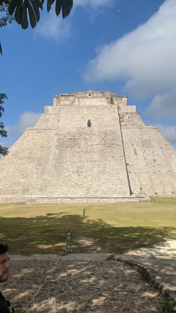 Ancient Mayan pyramid structure with steep steps.
