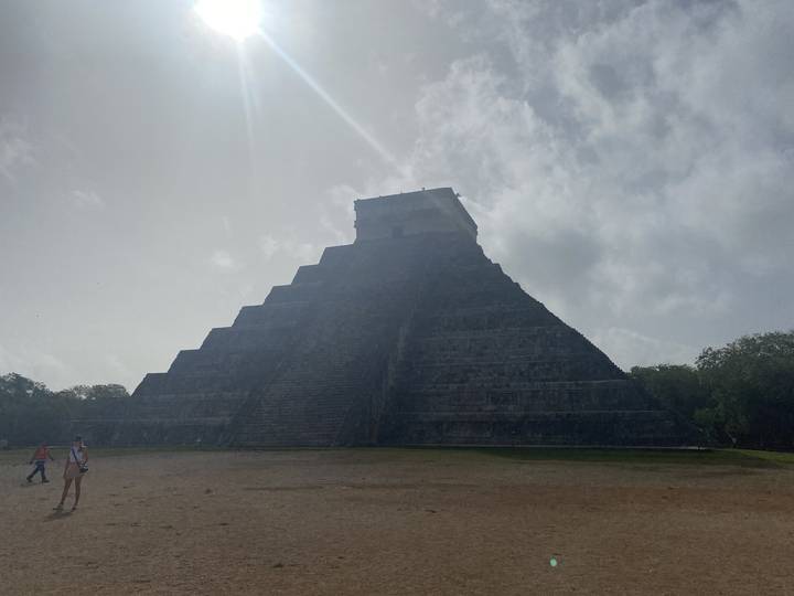 A large pyramid structure with people around.