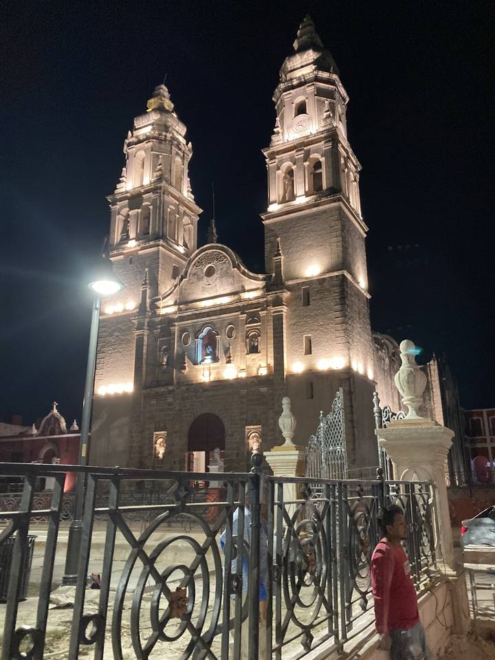 A brightly lit building with intricate architecture at night.