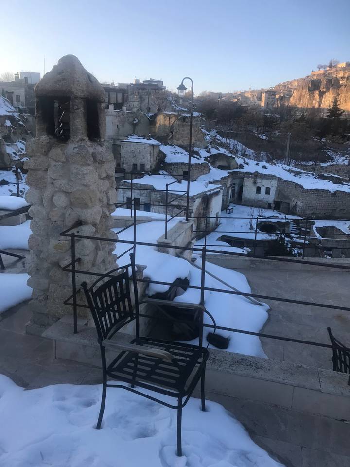 Snow-covered rooftop patio with a scenic view.