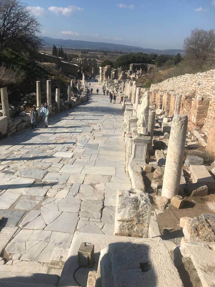 Ancient ruins lining a marble-paved street.