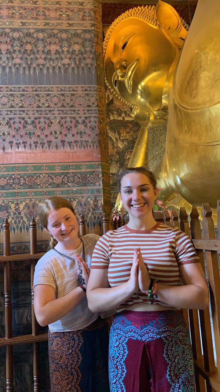 Two women posing inside a temple