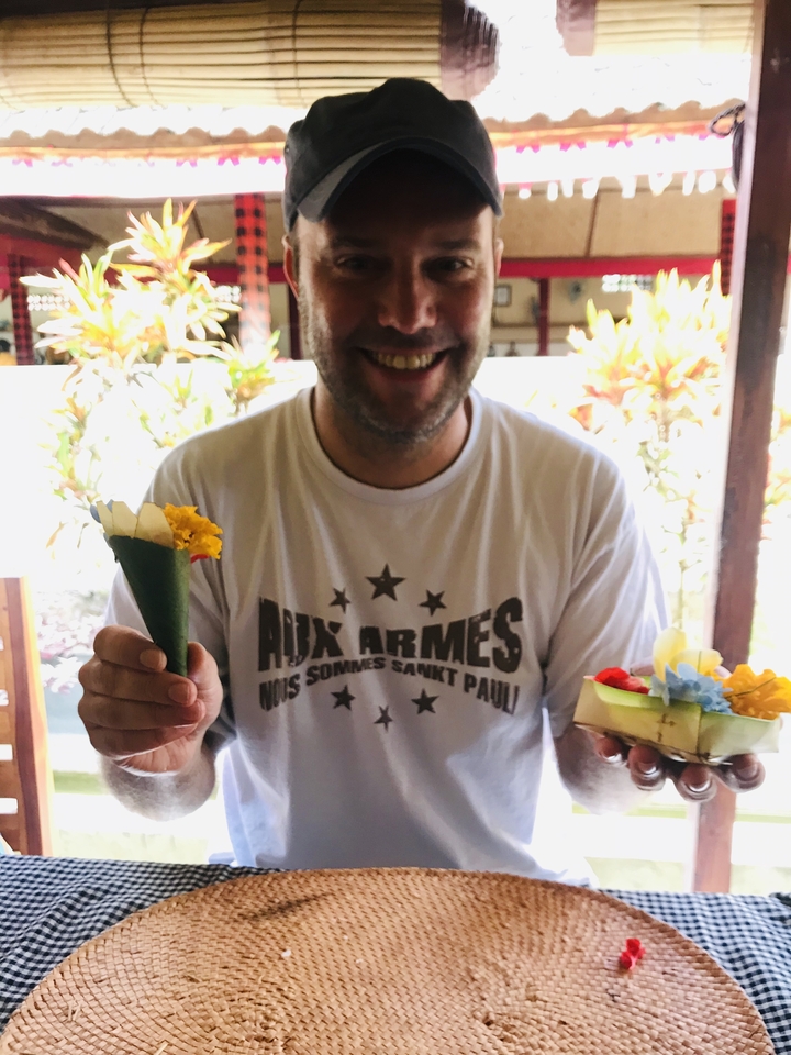 Person holding food offerings and smiling.