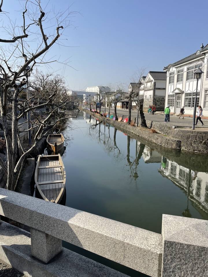 Canal with traditional buildings reflected in the water.